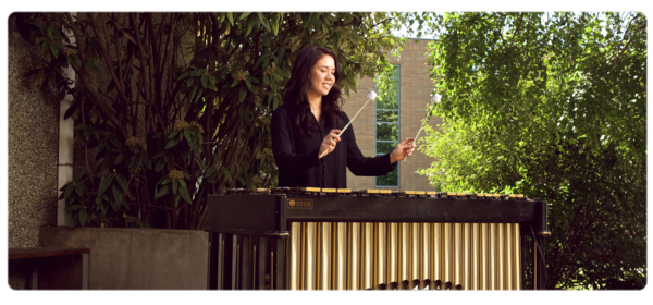 Musician playing percussion instrument outdoors